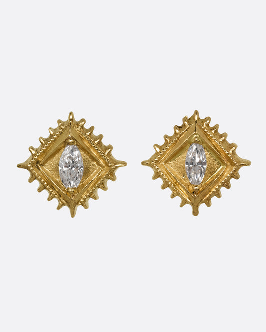 A pair of square yellow gold stud earrings with a milgrain border and white marquis diamond in the center. Shown from the front.