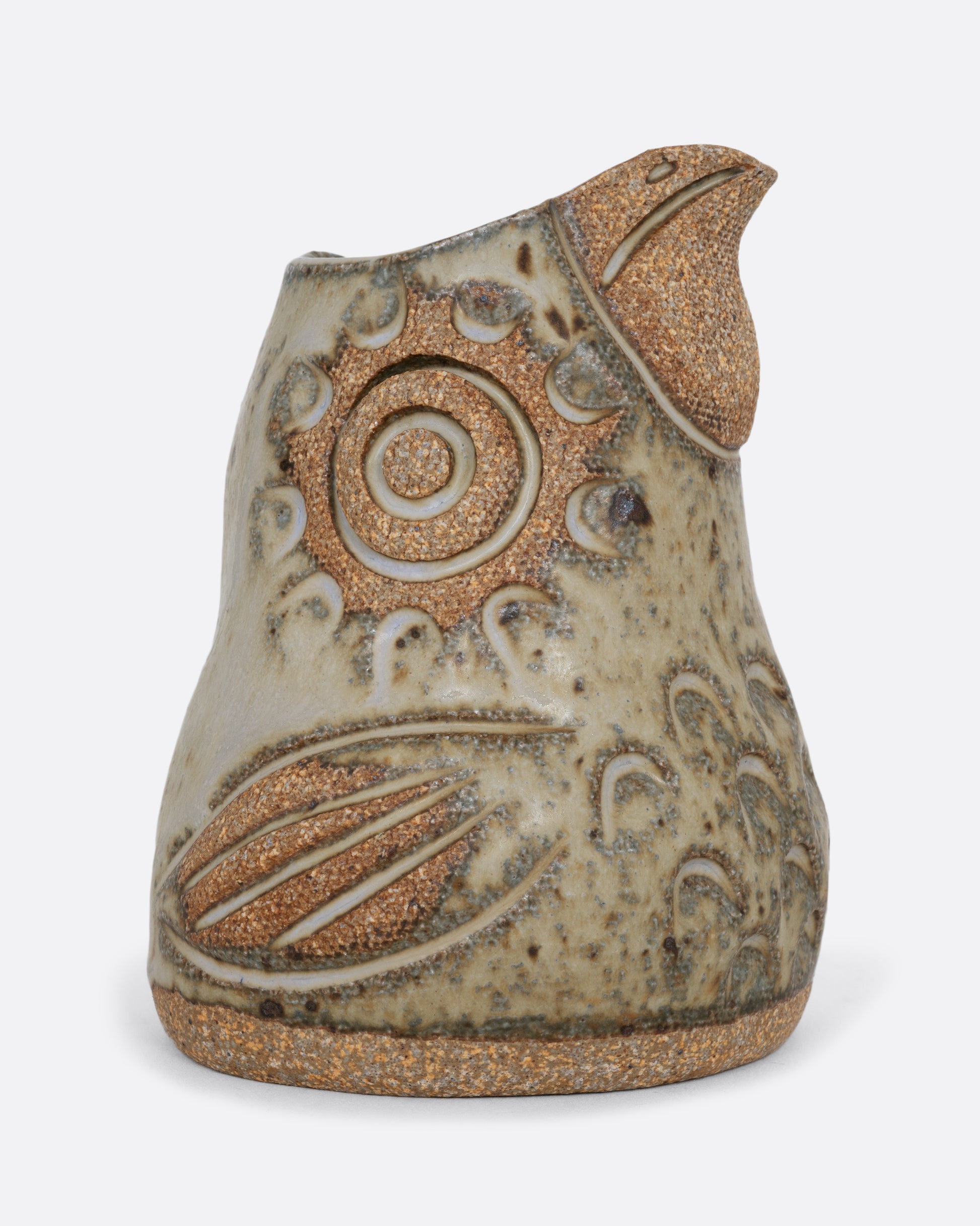 A spotted bird shaped creamer. Shown from the side.