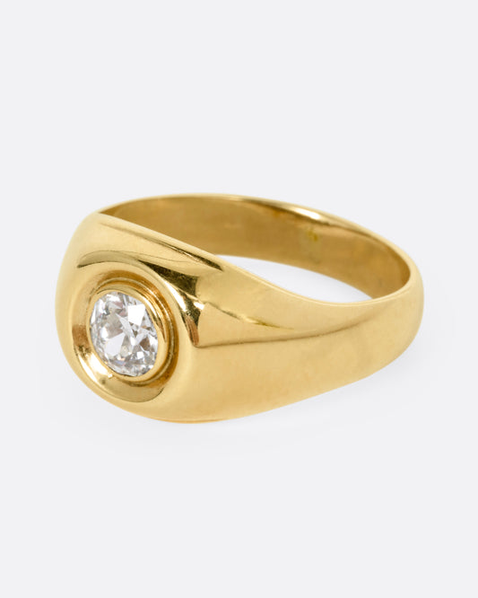 A yellow gold ring with a bezel set Old European Cut diamond. Shown from the side.