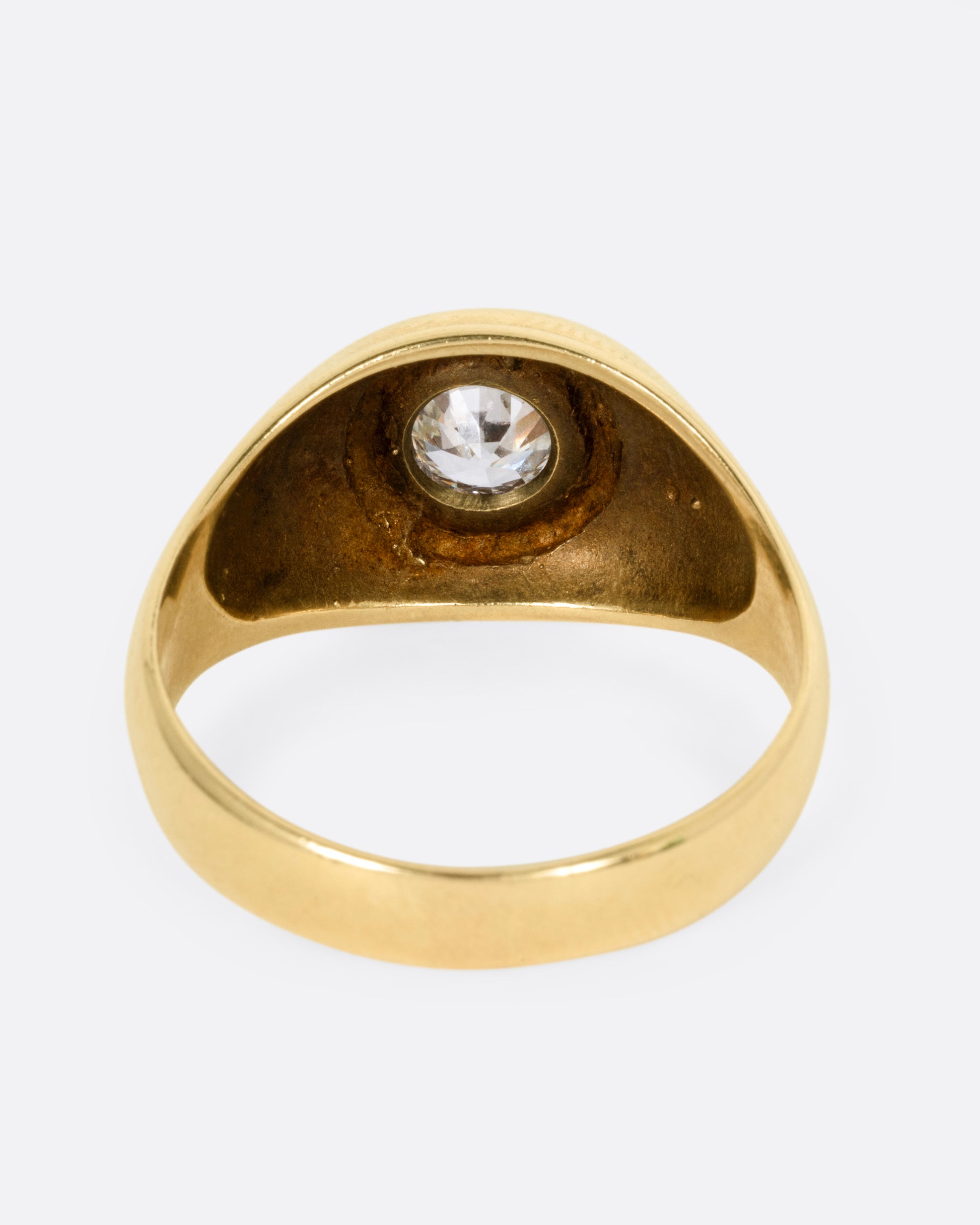 A yellow gold ring with a bezel set Old European Cut diamond. Shown from the back.