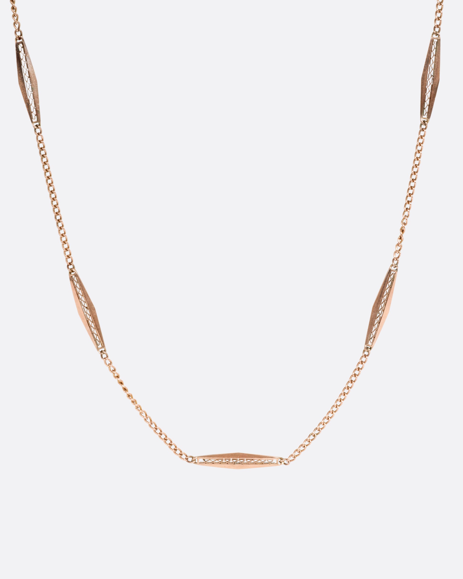 A rose gold bar link necklace shown from the front.