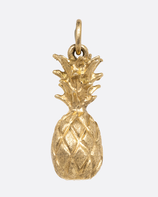 A yellow gold pineapple charm, shown from the front.
