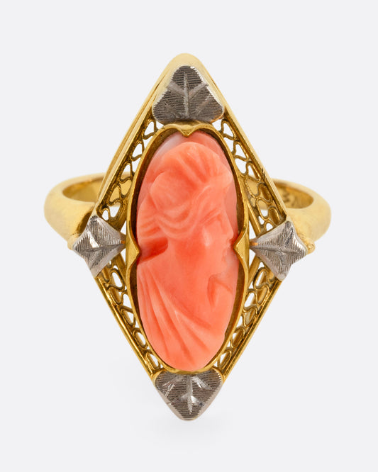 A yellow gold cameo ring with a coral carved portrait. Shown from the front.