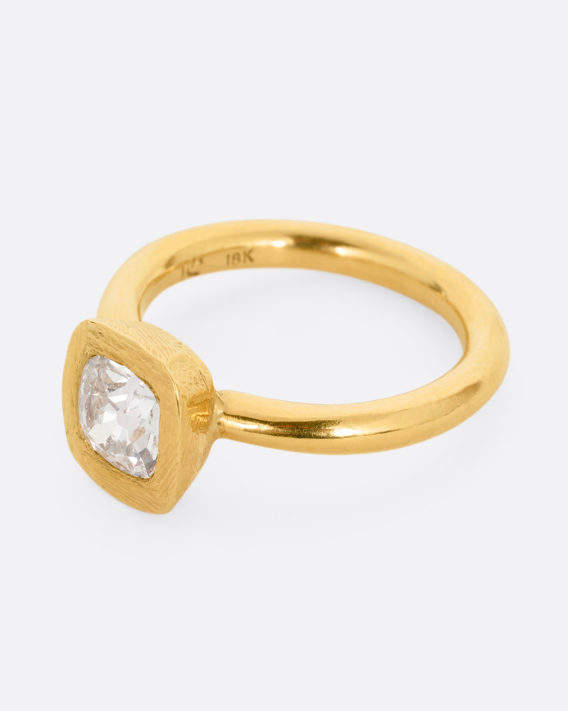 A yellow gold ring with an Old Mine Cut Diamond. Shown from the side.