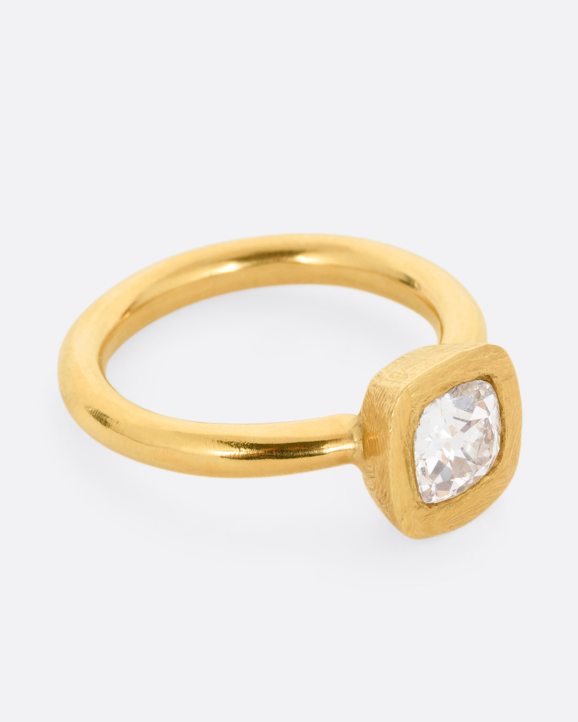 A yellow gold ring with an Old Mine Cut Diamond. Shown from the side.