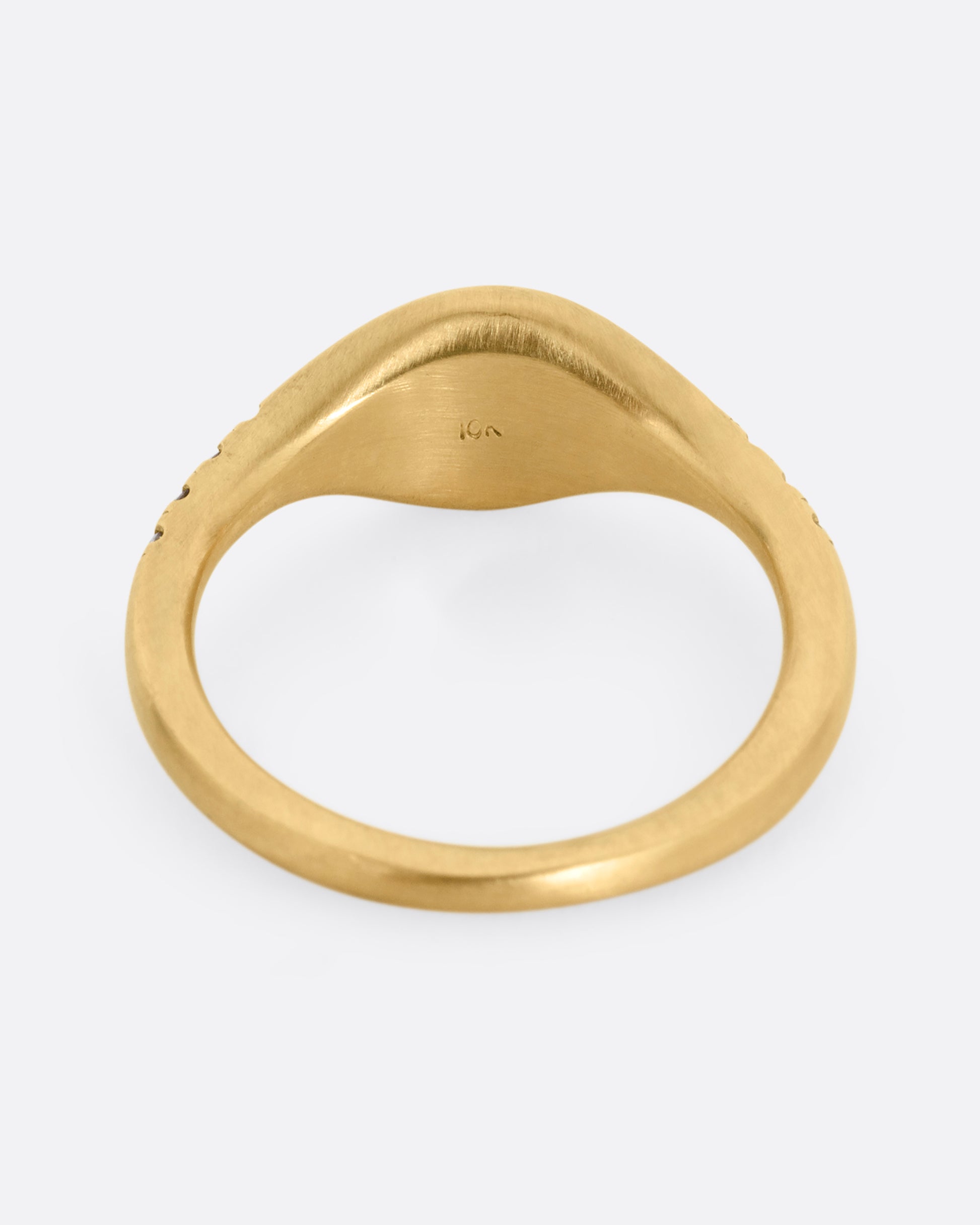 A yellow gold signet ring with diamonds on the shoulders. Shown from the back.
