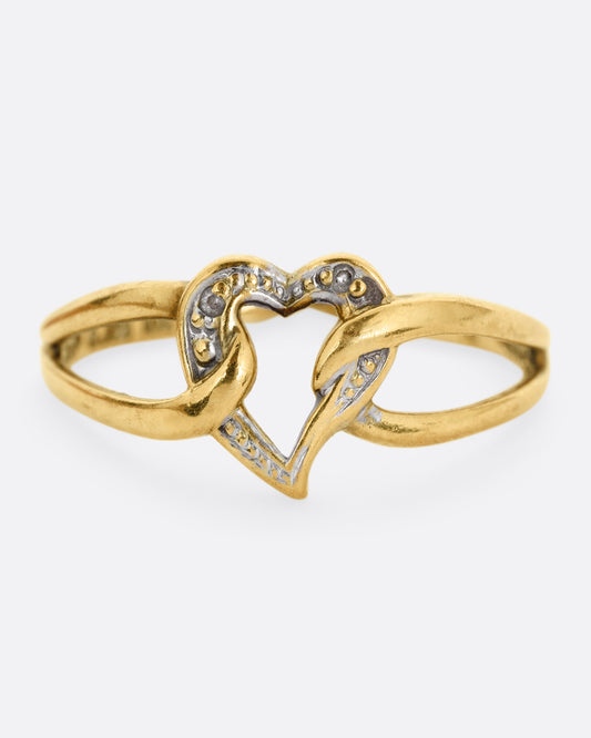 A yellow and white gold ring with an open heart and looped shoulders. Shown from the front.