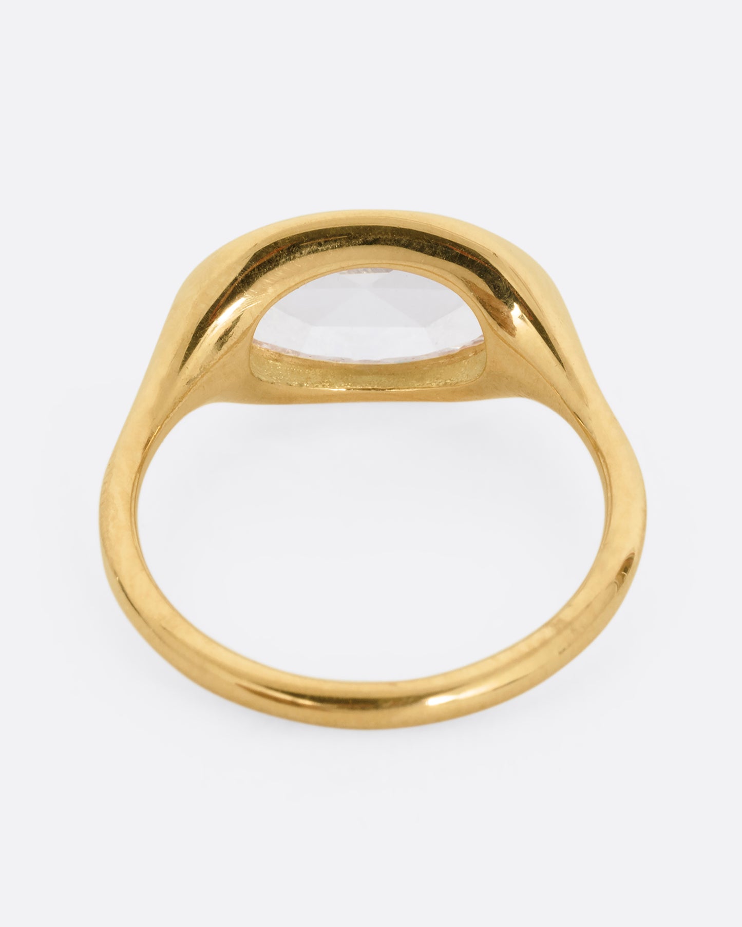 A yellow gold ring with a n oval rose cut diamond. Shown from the back.
