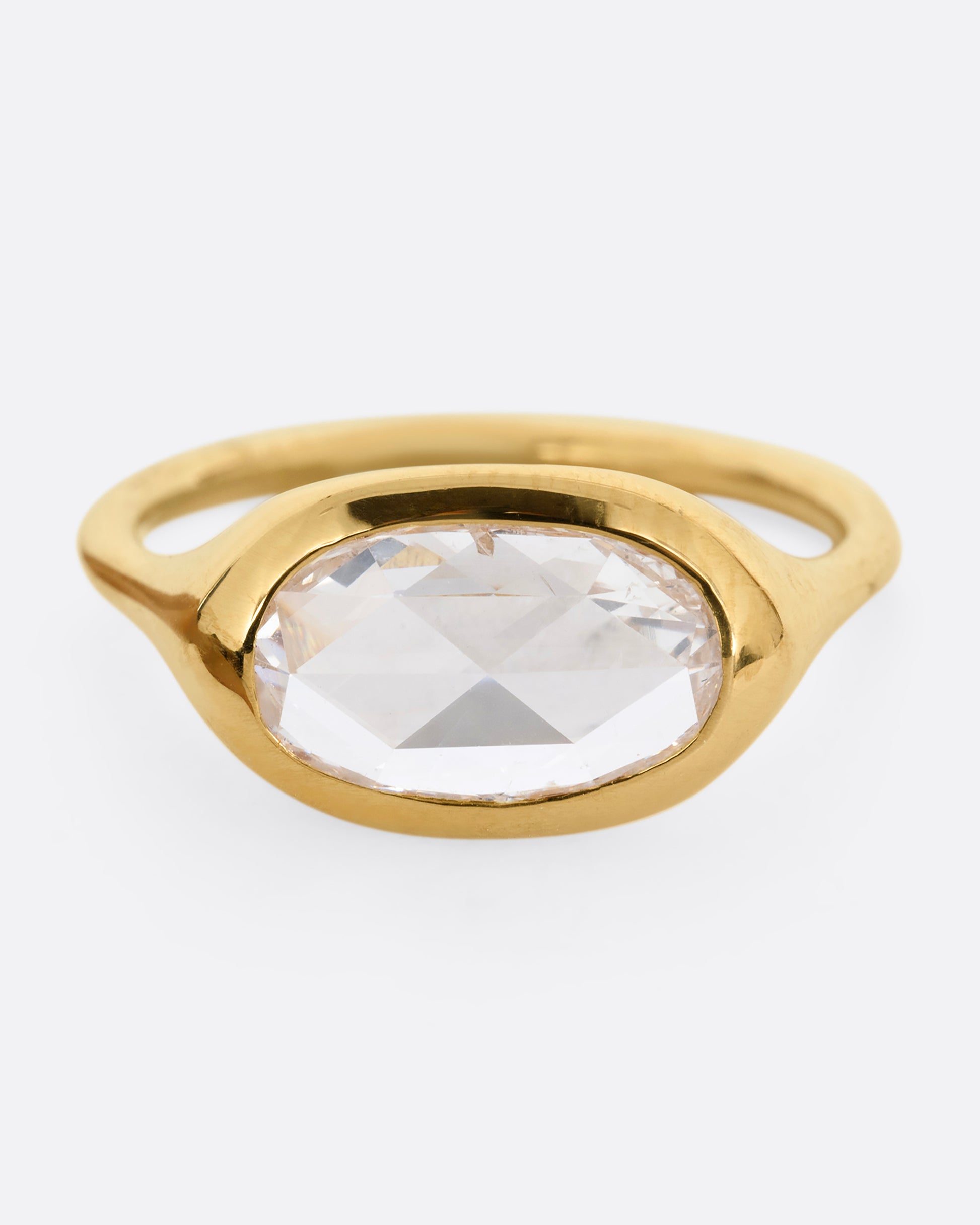 A yellow gold ring with a n oval rose cut diamond. Shown from the front.