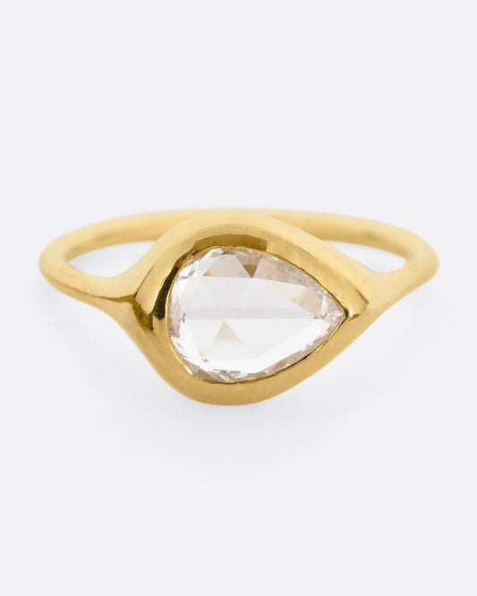 A yellow gold band with a rose cut pear shaped diamond. Shown from the front.