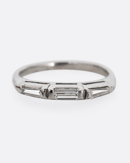 A platinum ring with three baguette diamonds. Shown from the front.