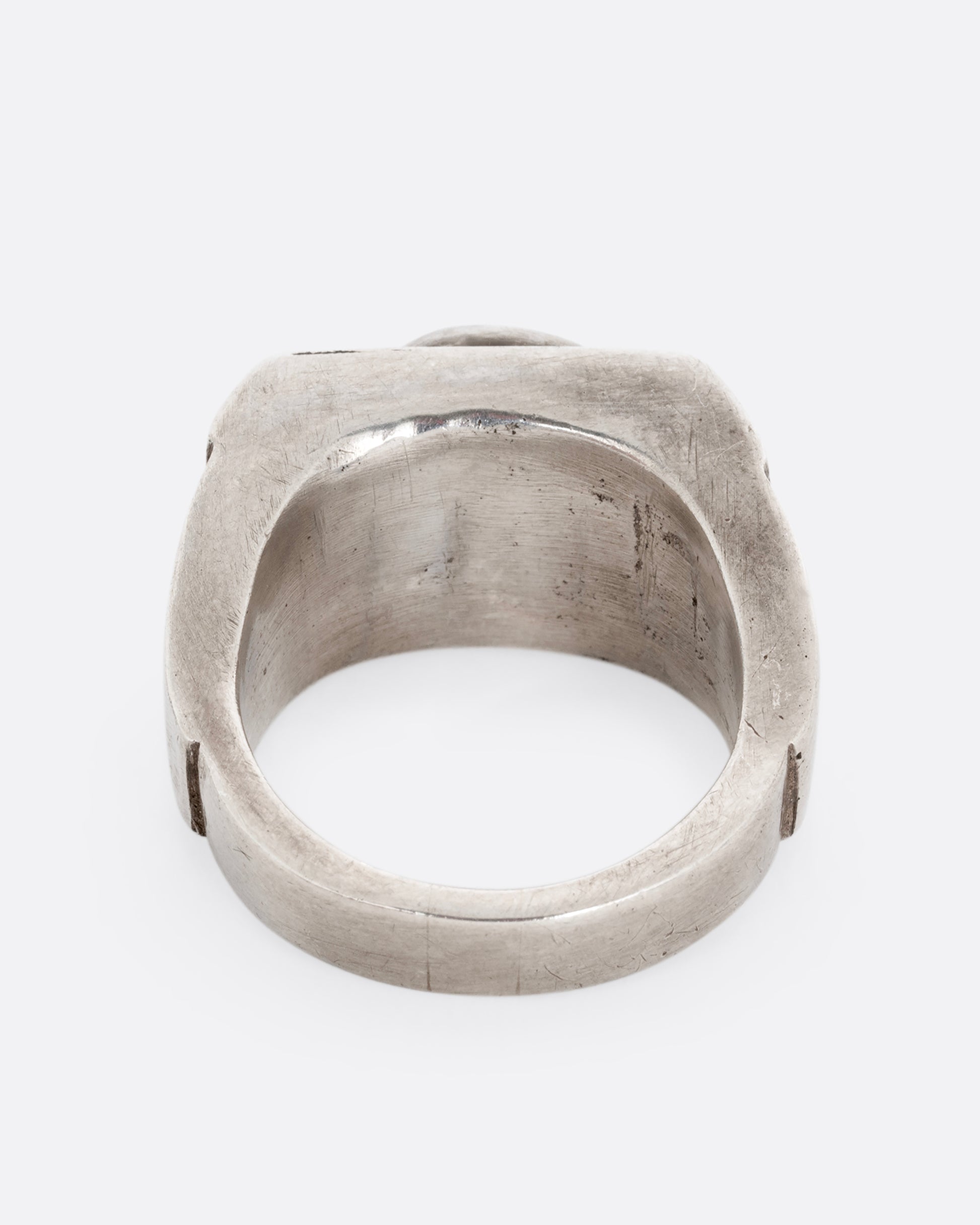 A silver ring with an oval onyx. Shown from the back.