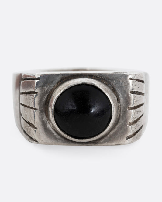 A silver ring with an oval onyx. Shown from the front.