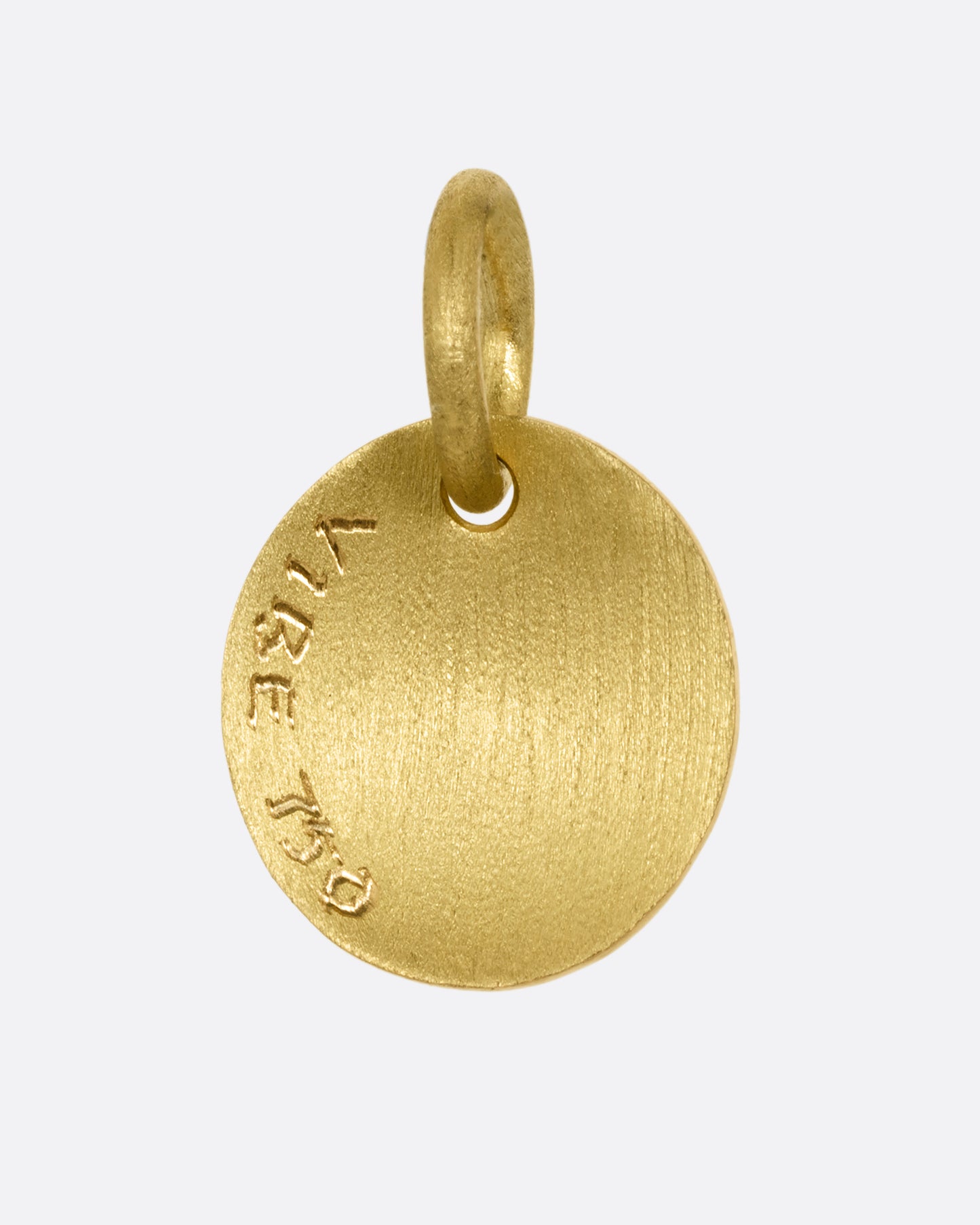 A yellow gold medallion with a diamond and mushrooms. Shown from the back.