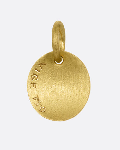 A yellow gold medallion with a diamond and mushrooms. Shown from the back.