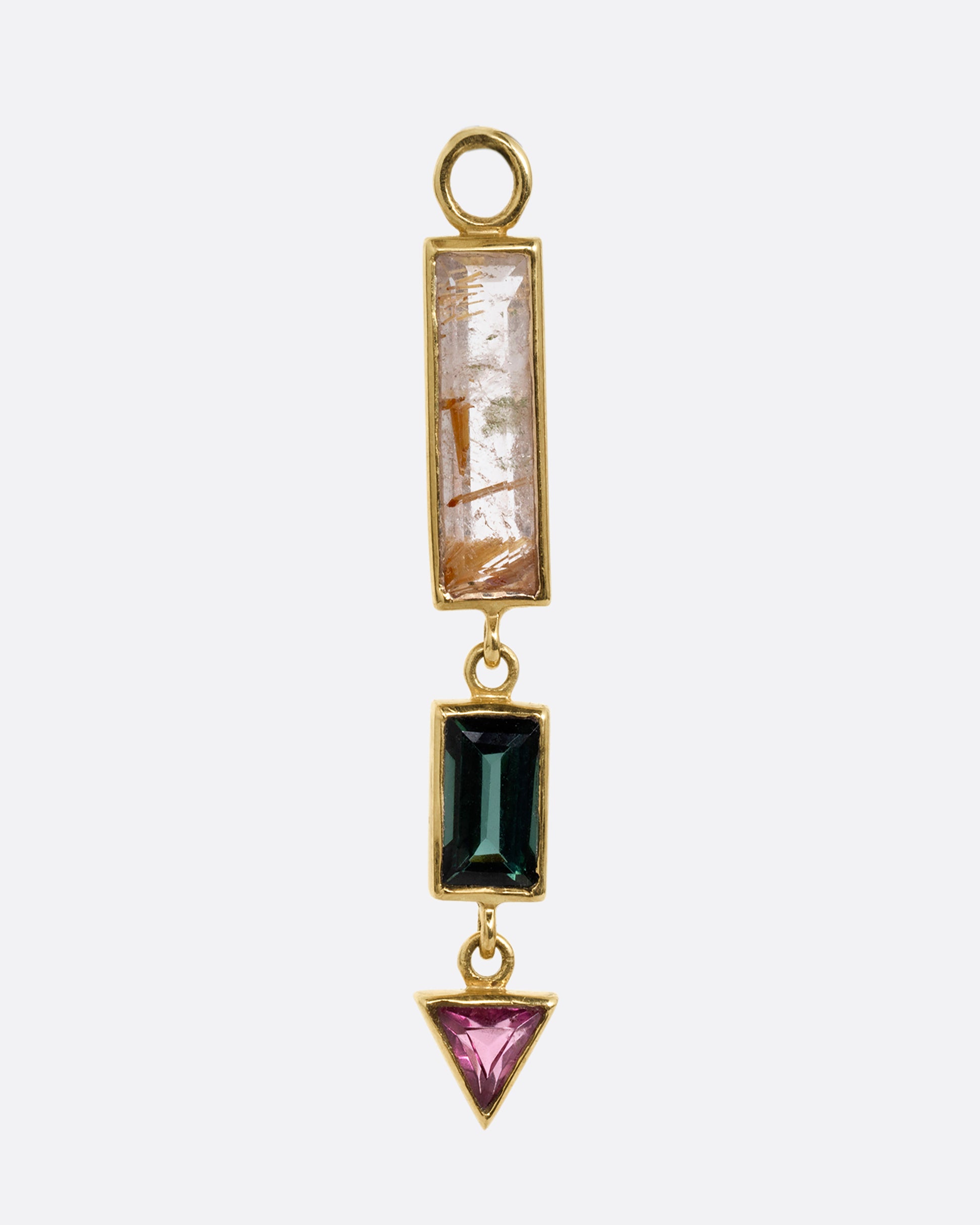 A yellow gold dangle with a rectangular rutilated quartz top, a small green rectangular tourmaline, and a pink tourmaline triangle. Shown from the front.