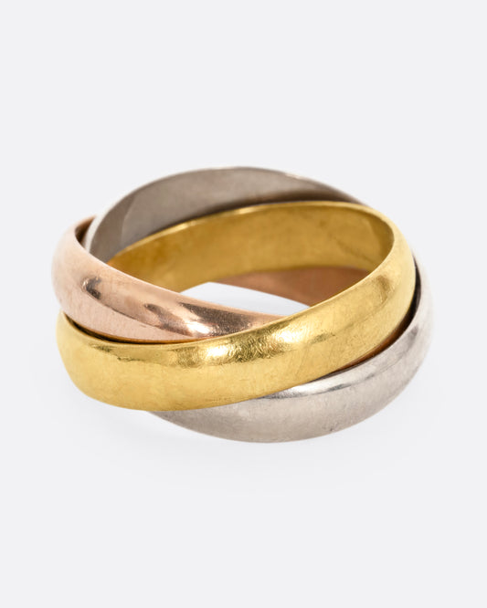 A ring with three interlocking bands in yellow, rose, and white gold, shown from the front.