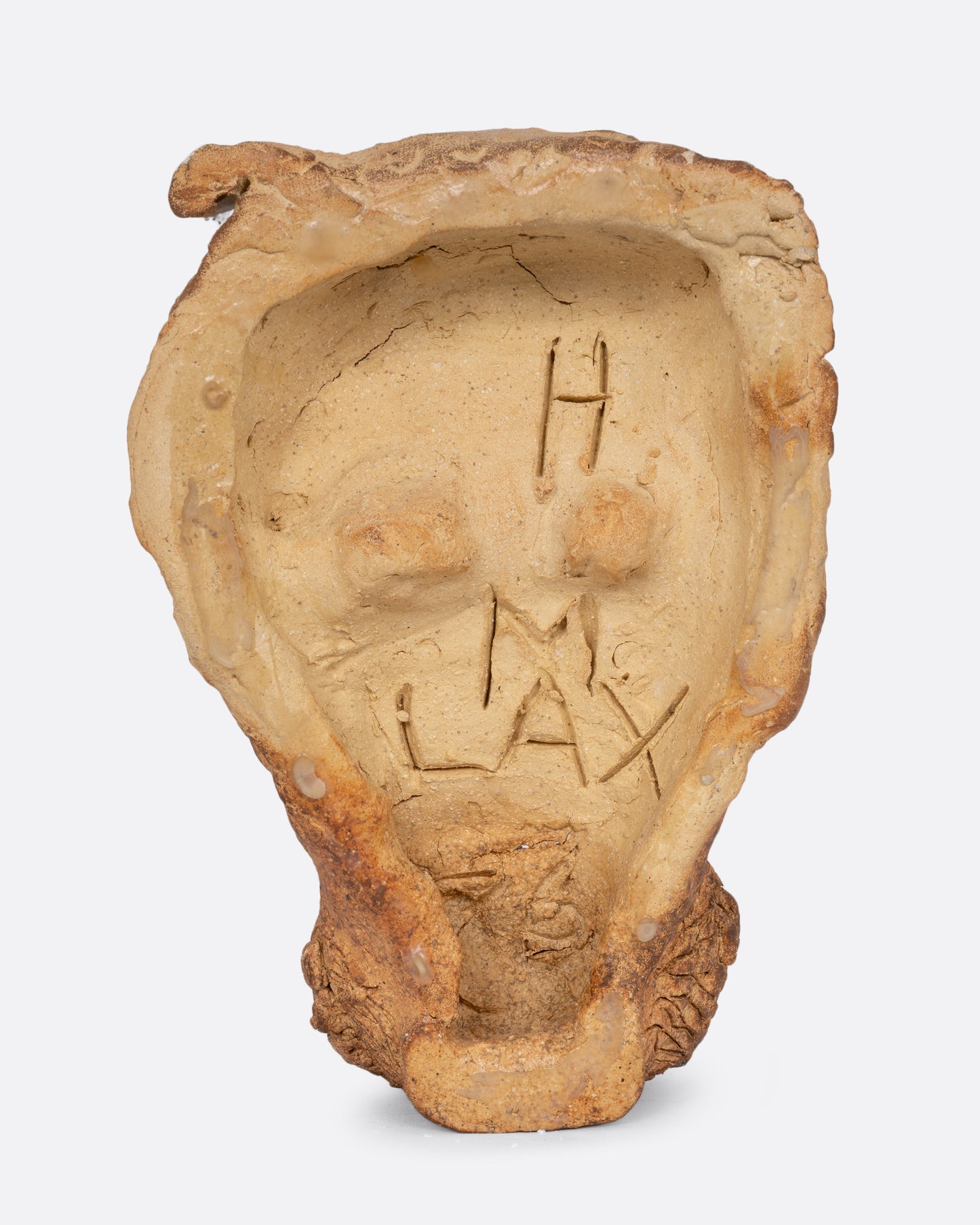 A handmade ceramic mask with a beard and hat. Shown from the back.
