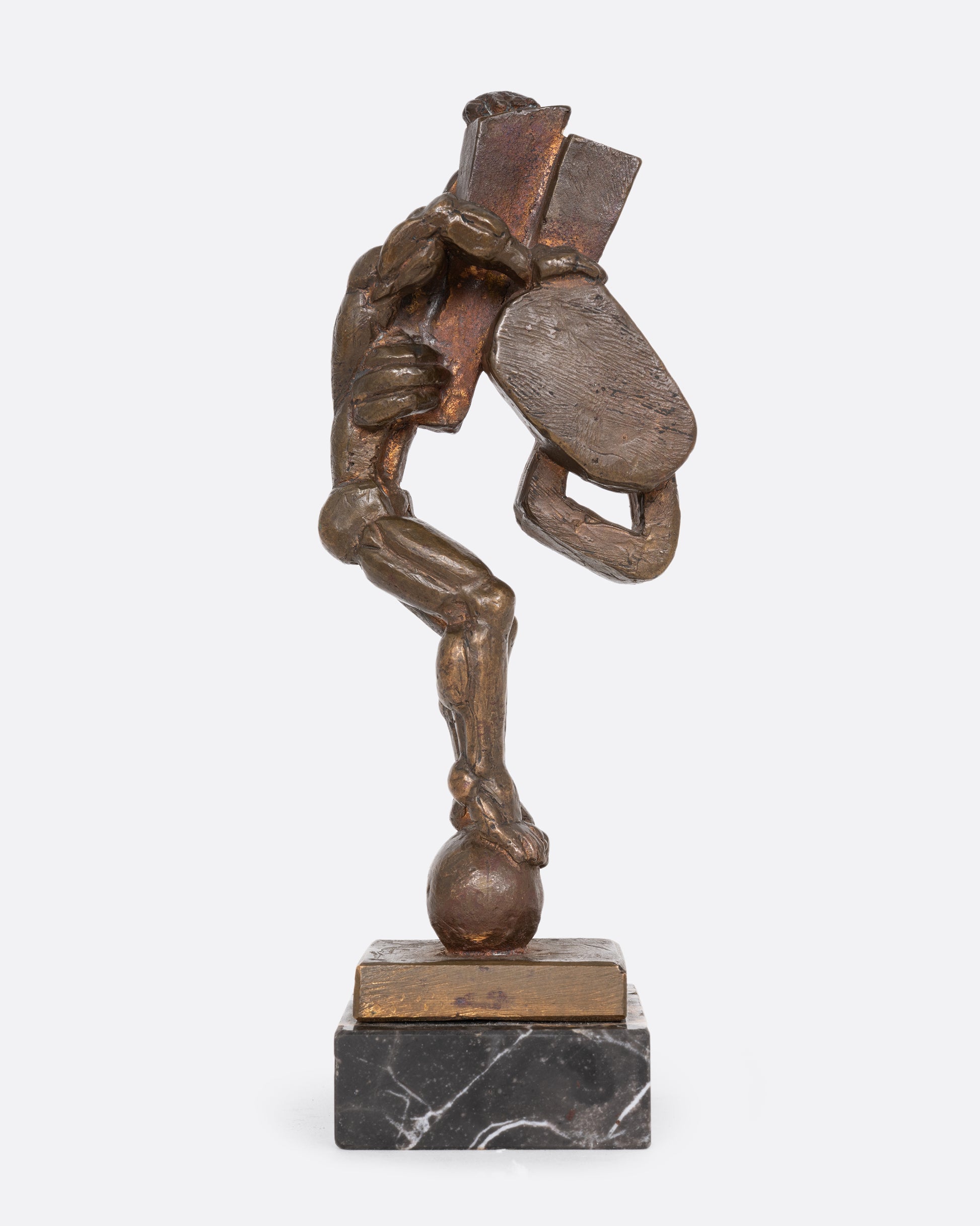 A Brutalist sculpture with geometric shapes and a human figure. Shown from the side.