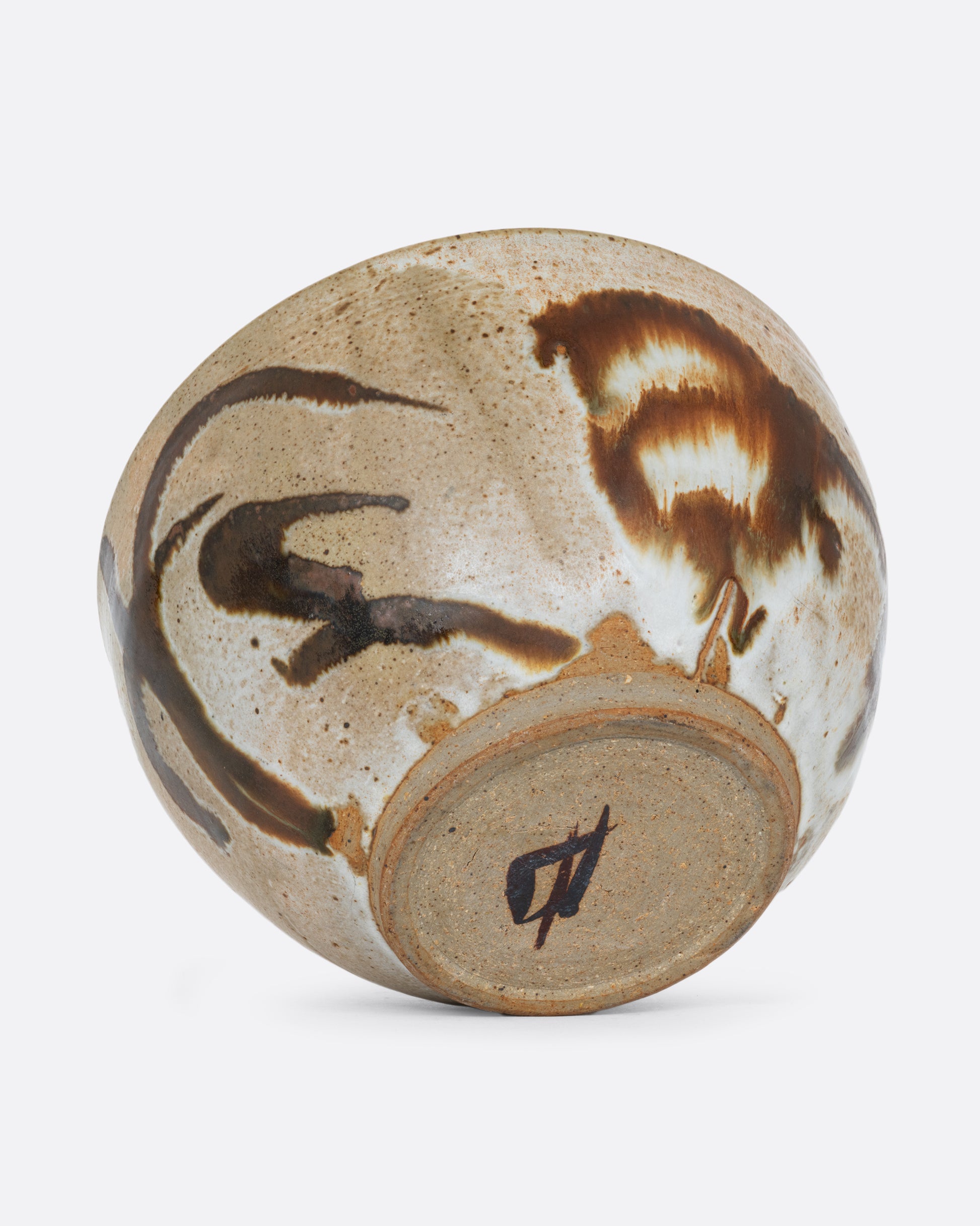 A brown bowl with brown brushstrokes all over. Shown on its side from the bottom.