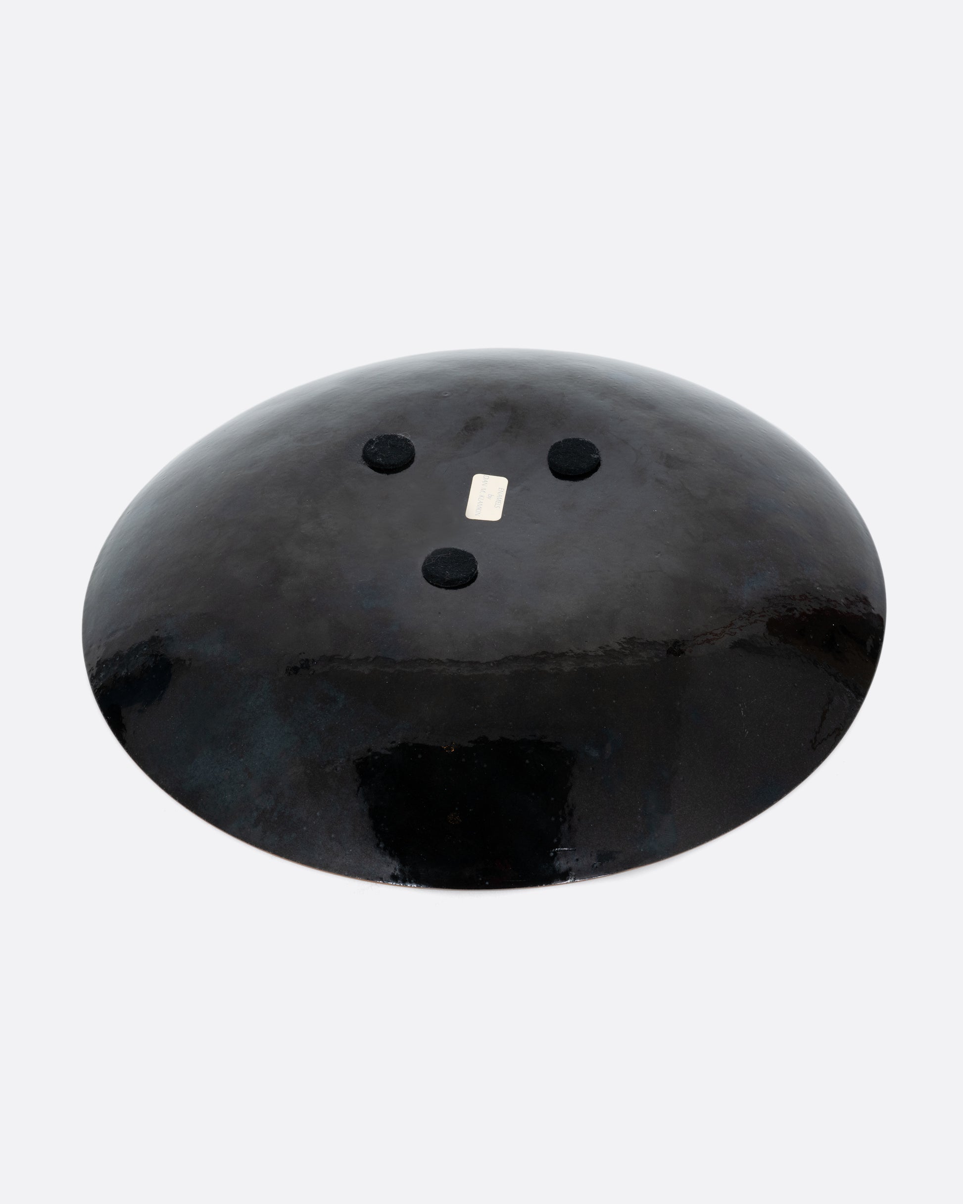  A colorful spotted enamel plate. Shown from the back.