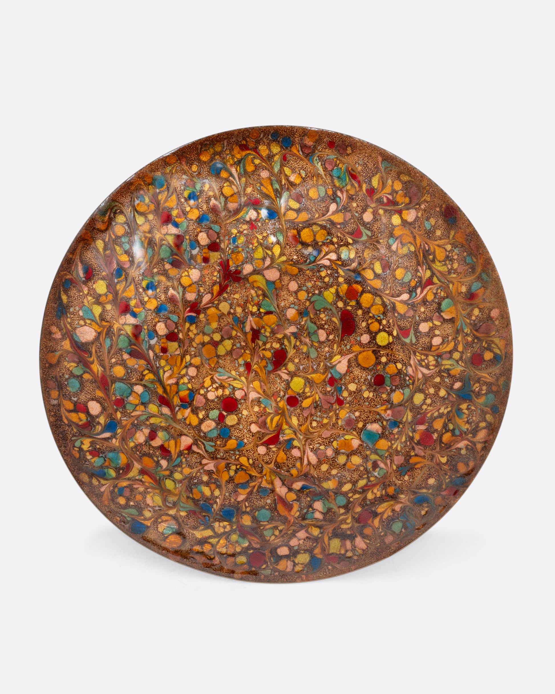  A colorful spotted enamel plate. Shown from the top.