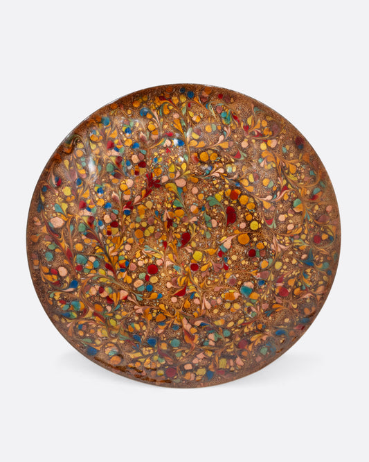  A colorful spotted enamel plate. Shown from the top.