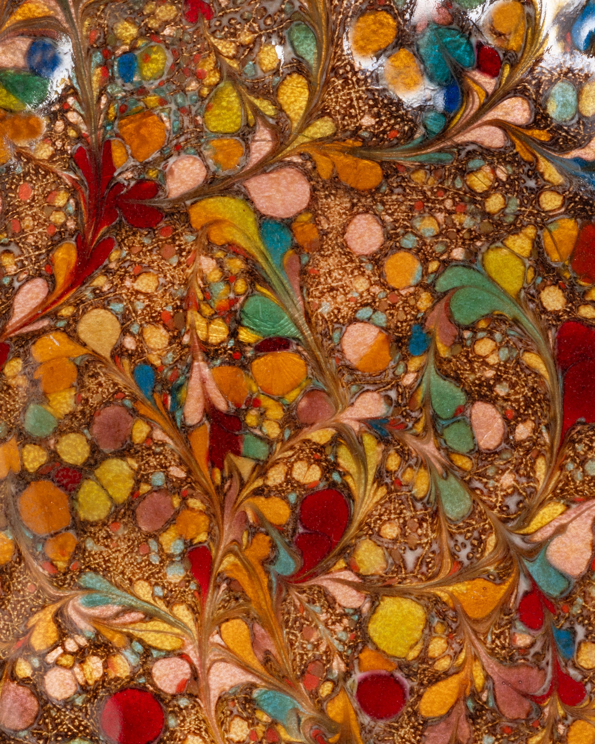  A close up of a colorful spotted enamel plate. Shown from the top.