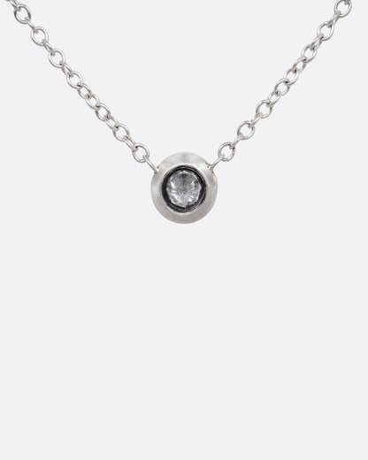 A silver cable chain necklace with a reverse set grey diamond. Shown from the front.