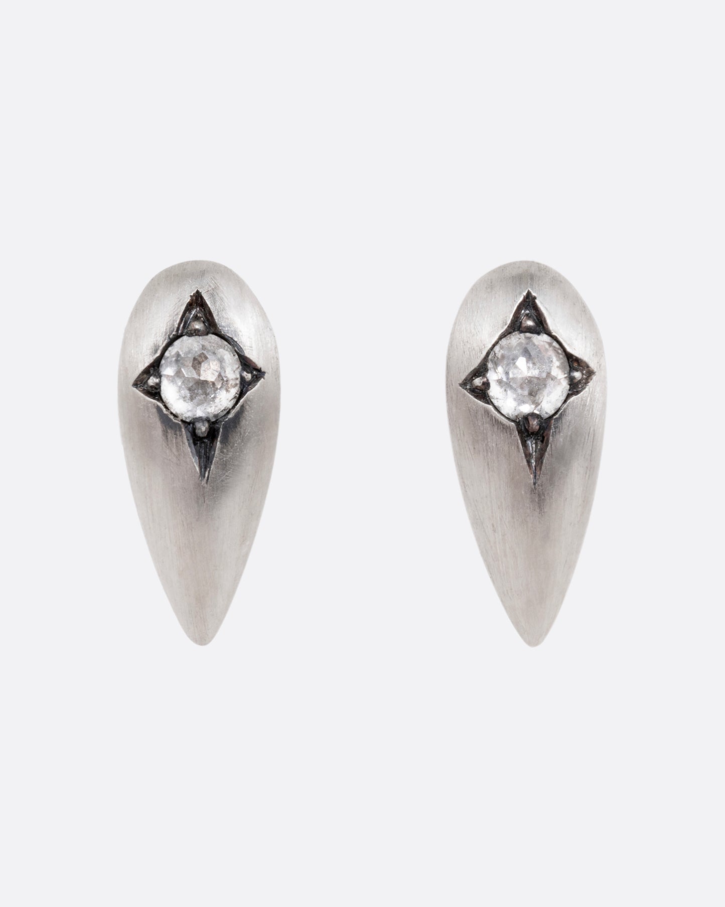 Silver teardrop shaped earrings with rose cut diamonds. Shown from the front.