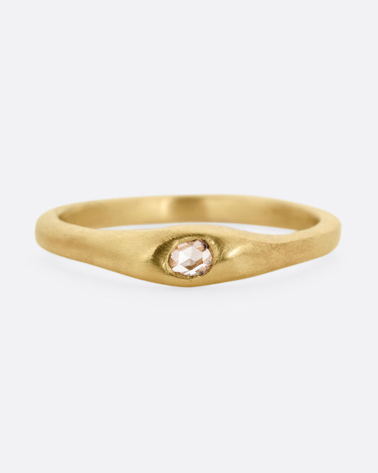 A yellow gold ring with a rose cut diamond. Shown from the front.