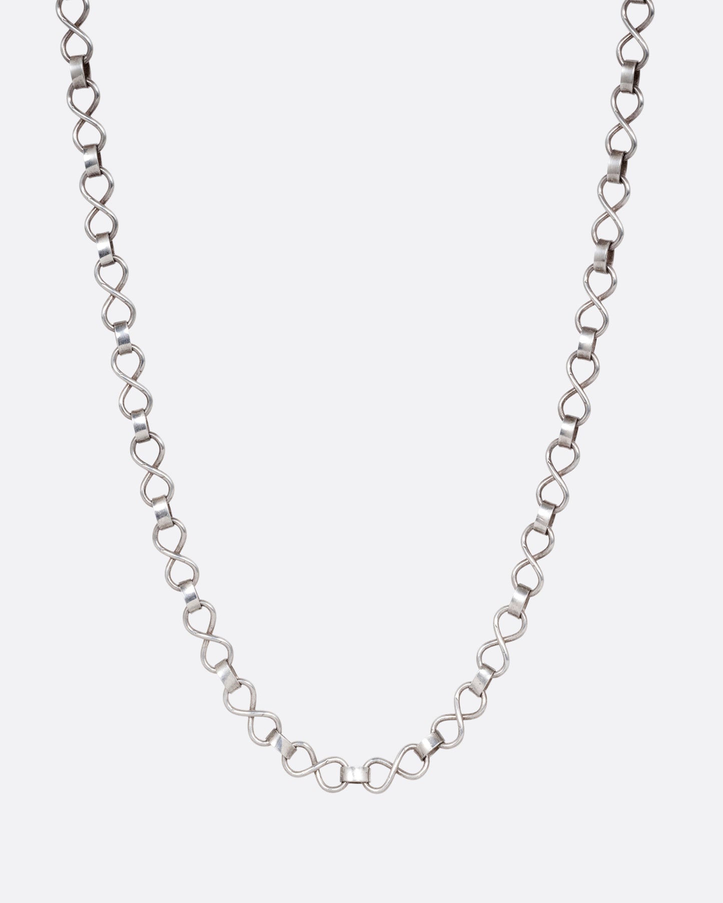 A silver  infinity link necklace. Shown from the front.