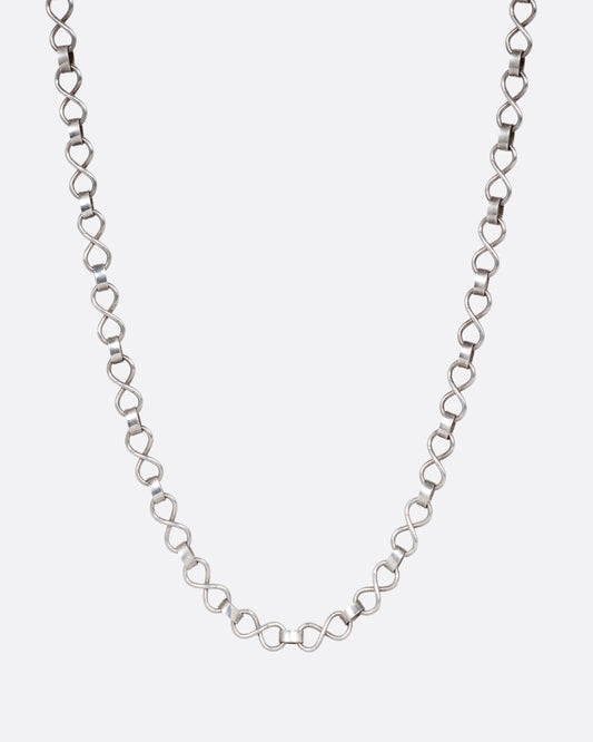 A silver  infinity link necklace. Shown from the front.
