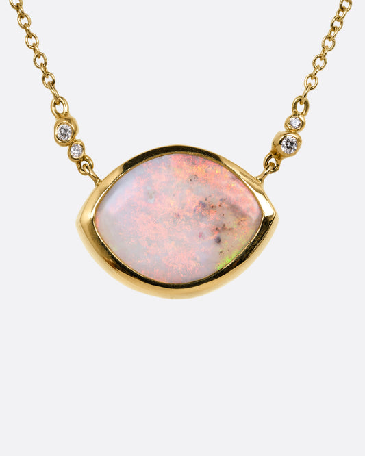 A yellow gold cable chain necklace with a large eye shaped opal pendant and diamond accents. Shown from the front.