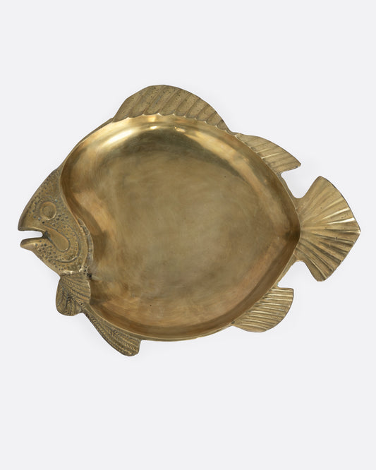 A brass fish shaped plate, shown from the top.