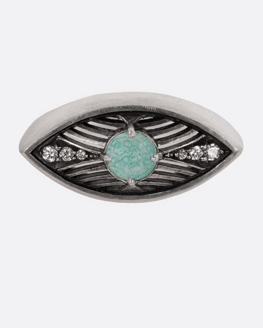 A silver eye shaped ring with a marbled Mexican turquoise cabochon and diamond details, shown from the front.