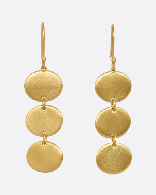 A pair of yellow gold dangle earrings with three linked ovals. Shown from the front.