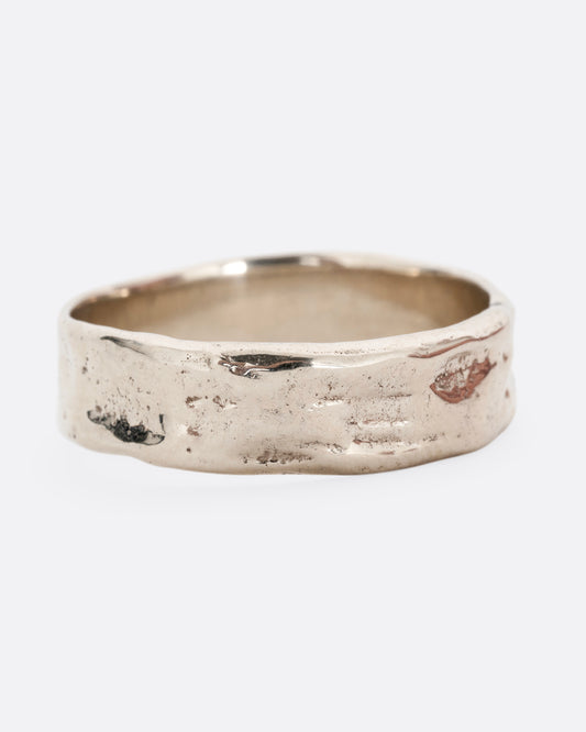 A white gold band with a textured and polished finish. Shown from the front.
