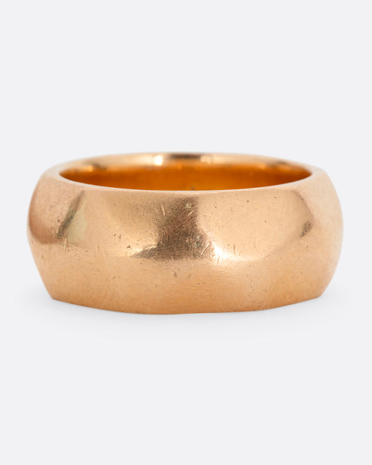 A wide hammered yellow gold cigar band. Shown from the front.
