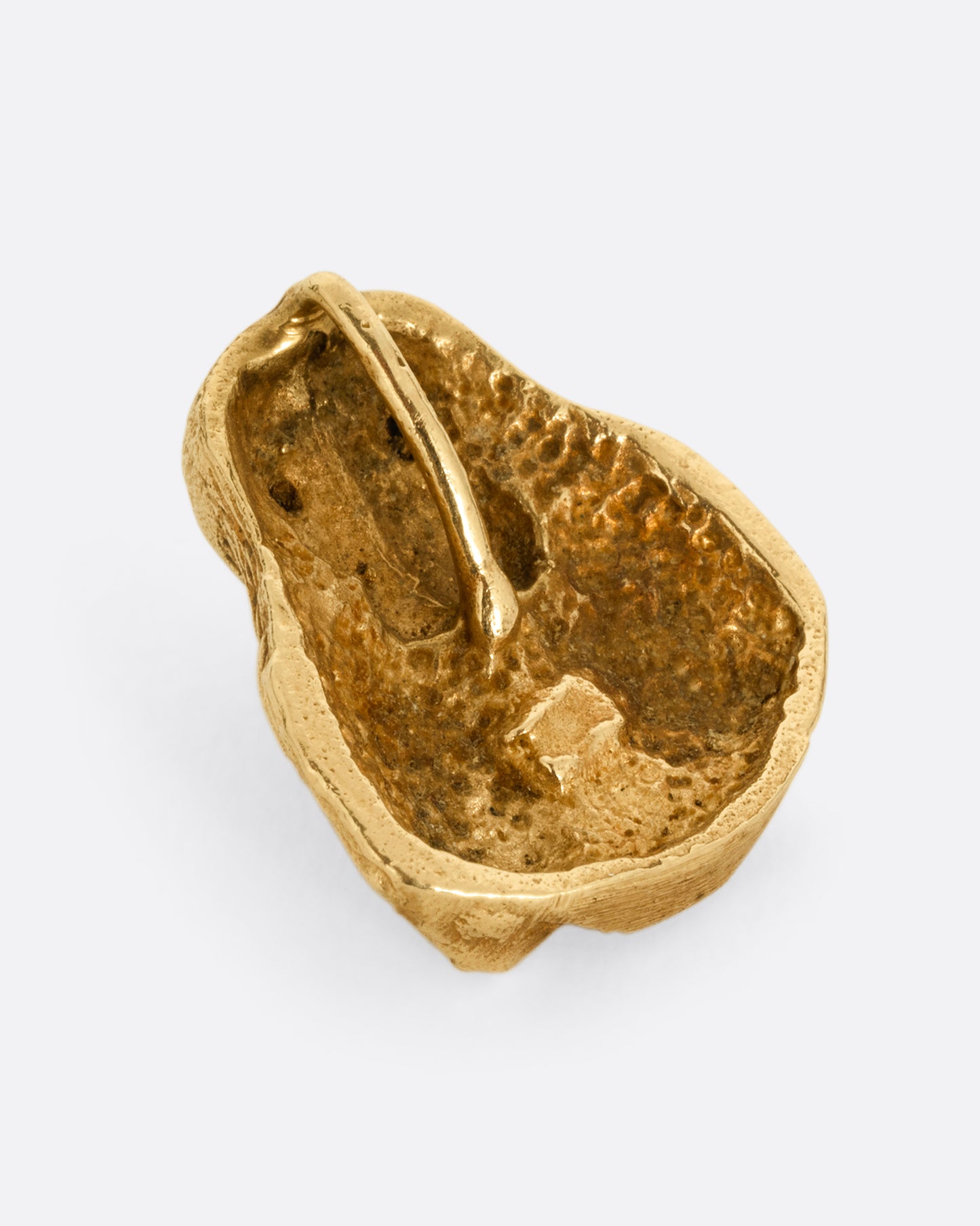 A yellow gold spaniel dog charm. Shown from the back.