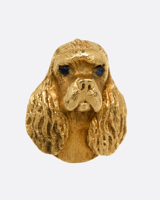 A yellow gold spaniel dog charm. Shown from the front.