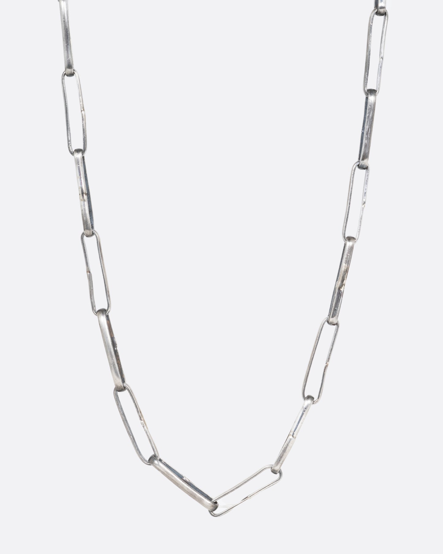 A silver wide link cable chain necklace. Shown from the front.