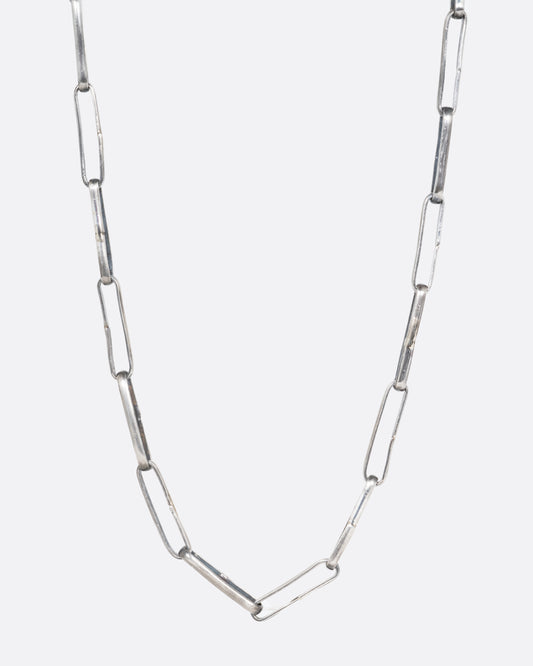 A silver wide link cable chain necklace. Shown from the front.