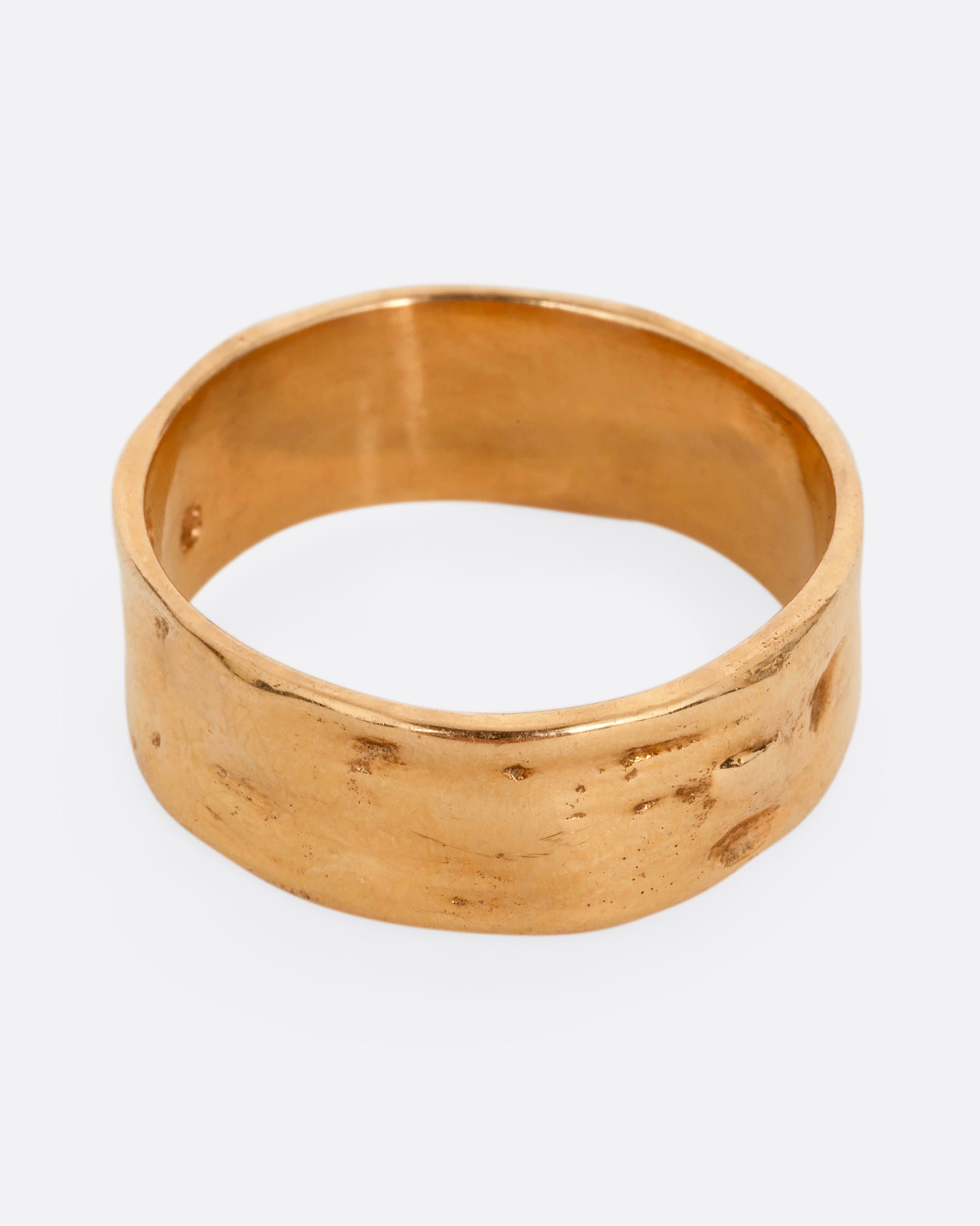 A rose gold band with a textured and polished finish. Shown from the front.