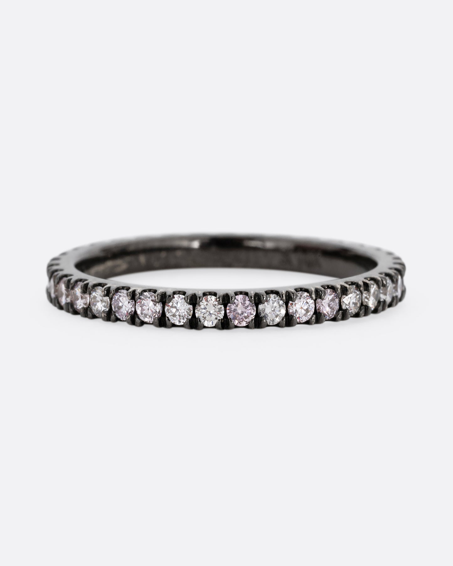 A white gold rhodium plated eternity band with pink, gray, and white diamonds. Shown from the front.