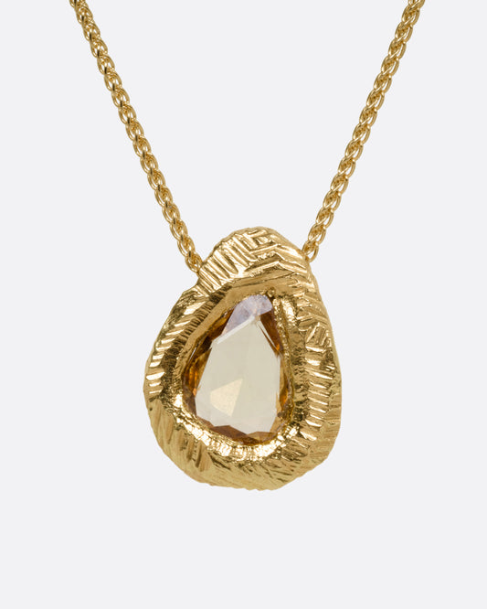 A yellow gold necklace with a yellow sapphire pendant, shown from the front.