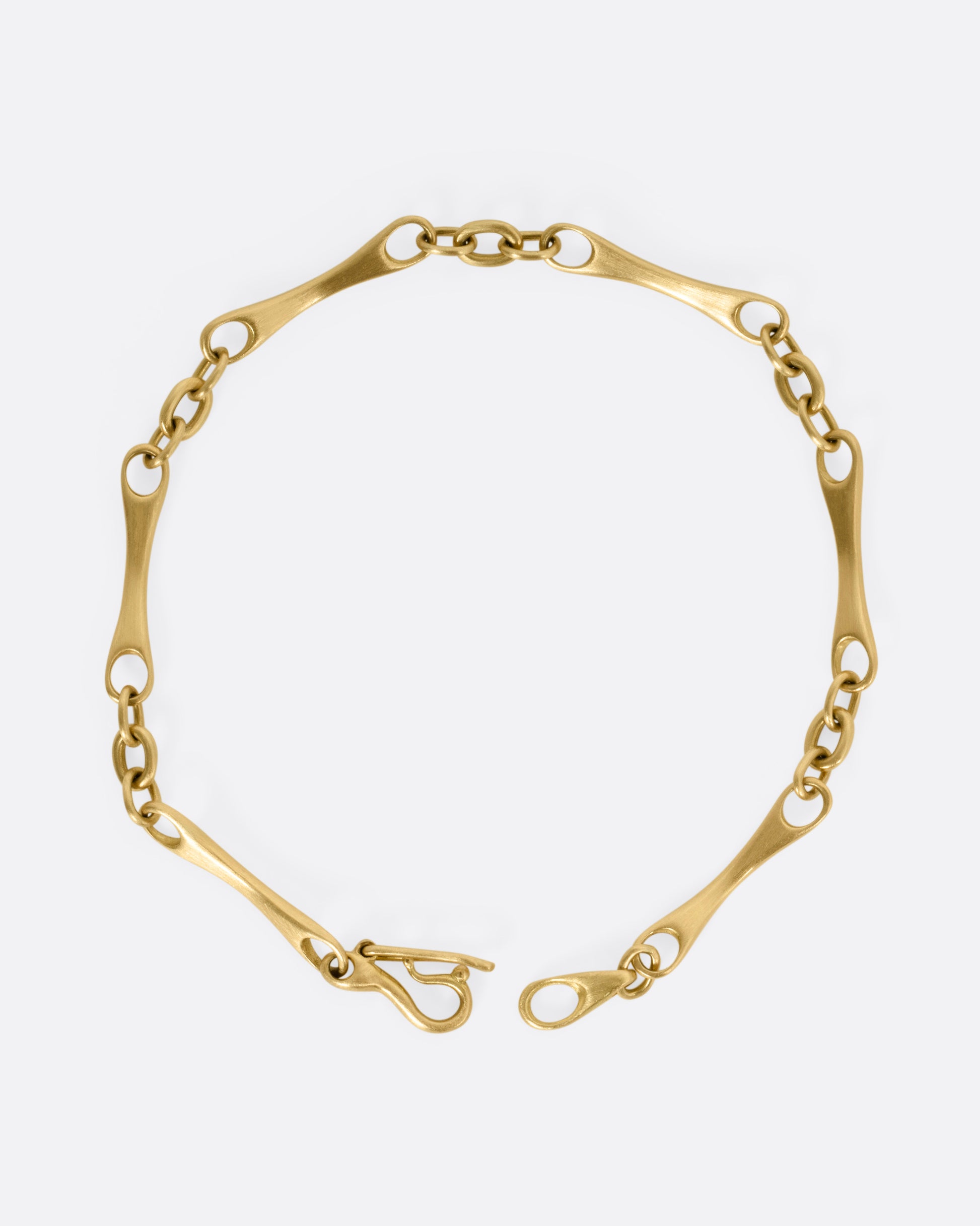 A yellow gold link bracelet, shown from the top open.