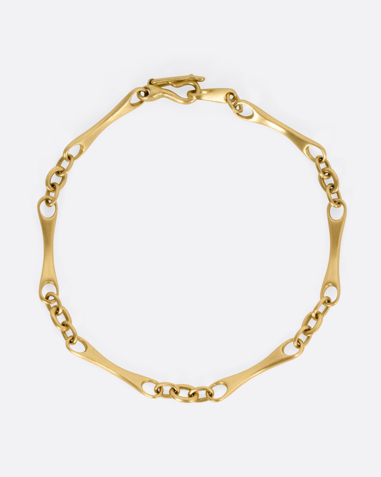 A yellow gold link bracelet, shown from the top.