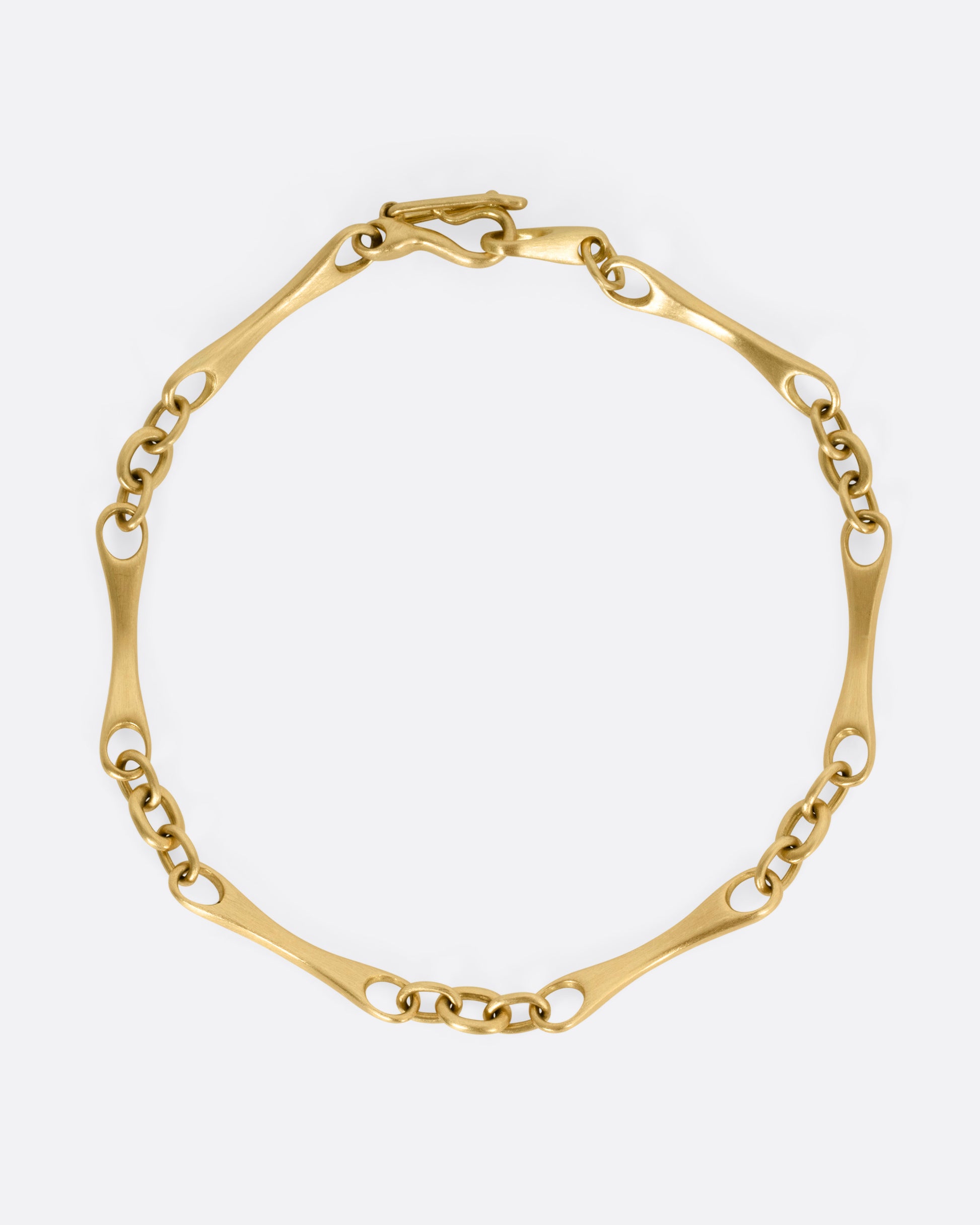 A yellow gold link bracelet, shown from the top.
