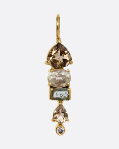 A yellow gold pendant with stacked tourmalines, sapphires, and diamonds, shown from the front.